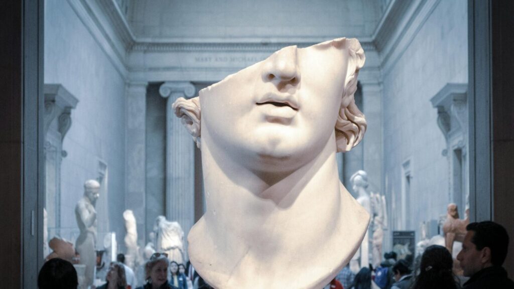 Greek marble head bust on display in a New York City museum exhibit.