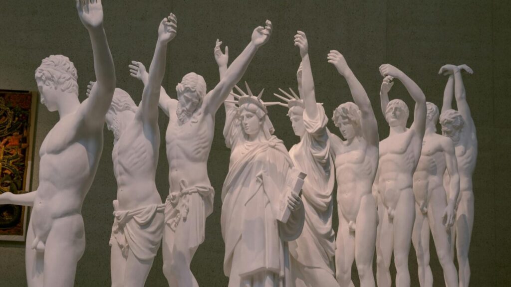 Intricate white statues displayed at a Canberra museum exhibition.