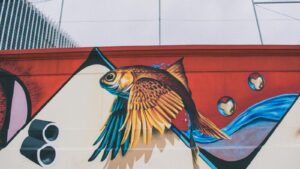 Vibrant fish mural capturing creativity and street art on an urban wall.